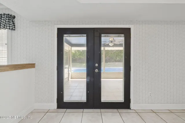 an aerial view of a house with swimming pool and garden
