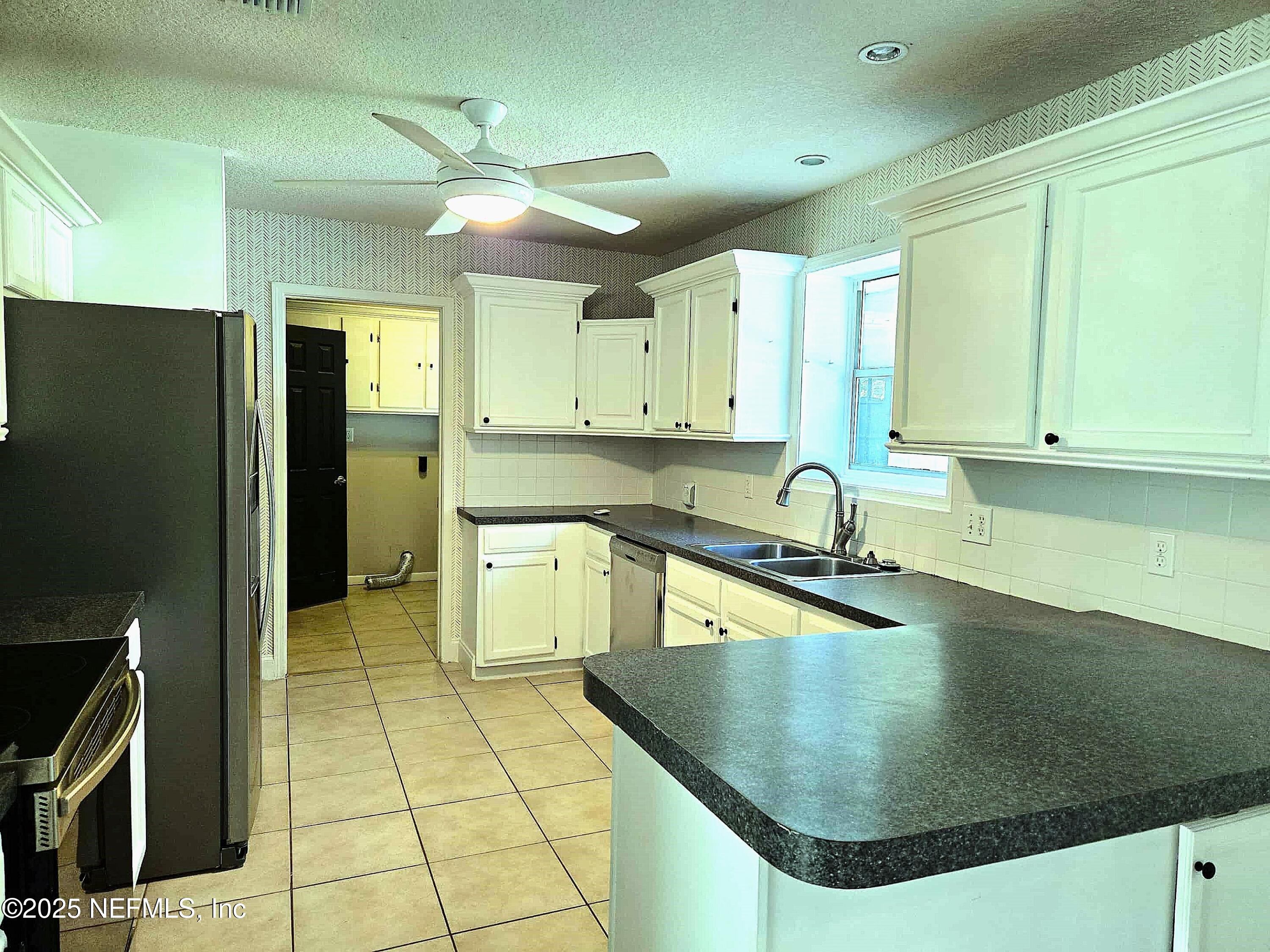 2822 Circle Ridge Drive Orange Park, FL 32065 - Photo 41 of 41 a kitchen with stainless steel appliances granite countertop a sink a stove and cabinets