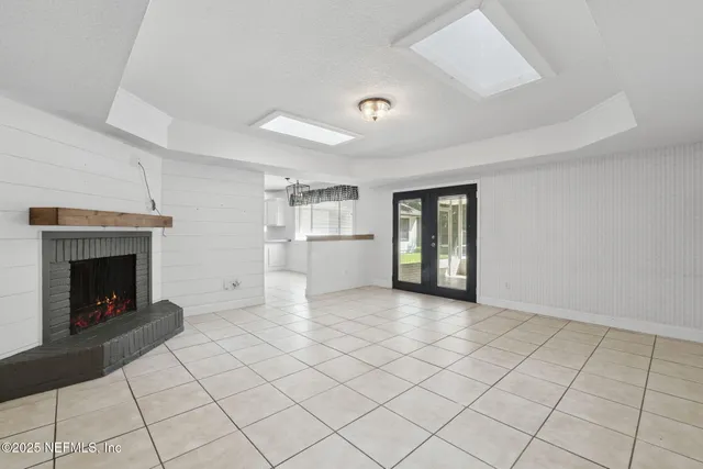 a kitchen with white cabinets and refrigerator