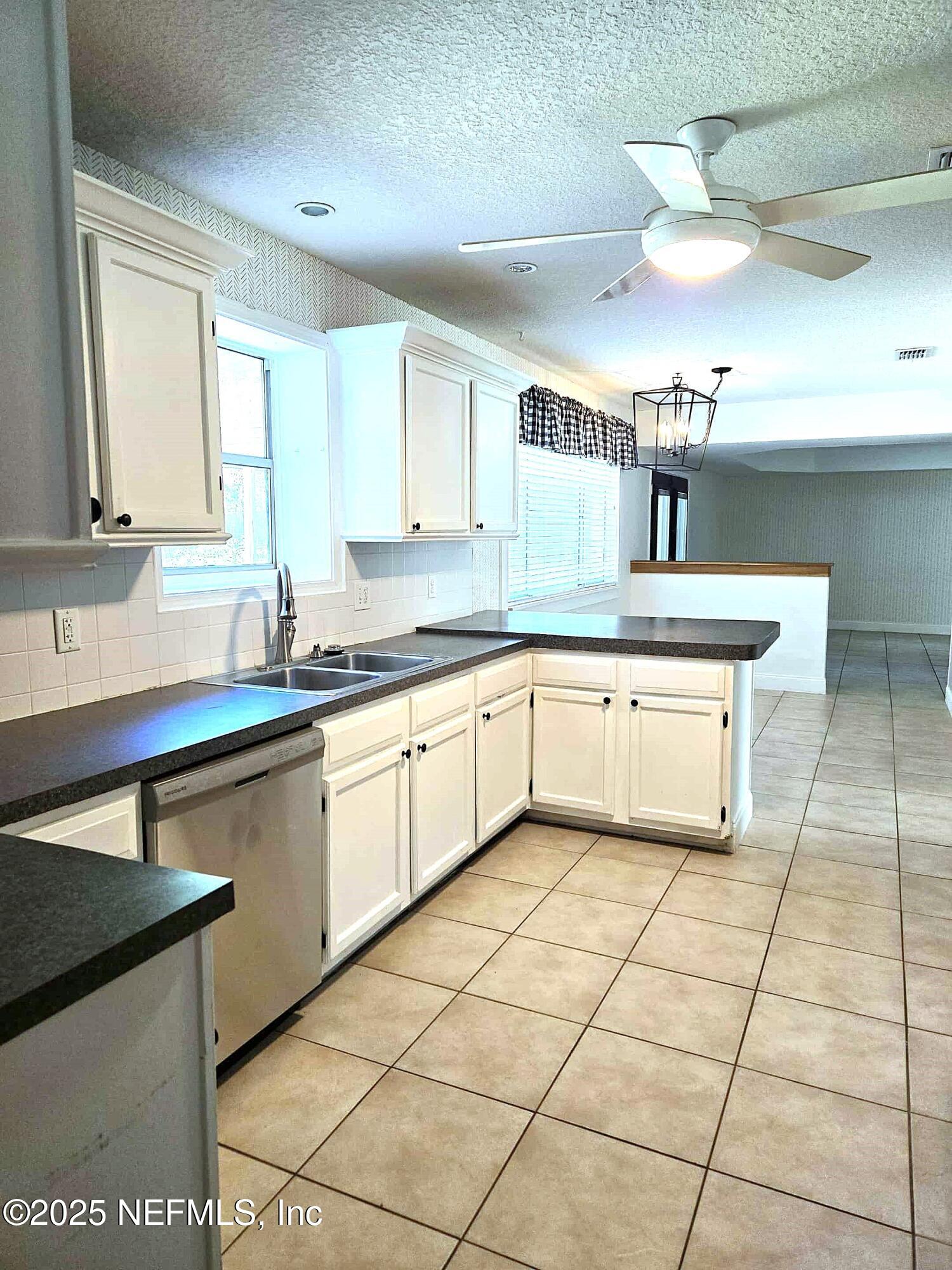 2822 Circle Ridge Drive Orange Park, FL 32065 - Photo 8 of 41 a kitchen with a sink a counter top space cabinets and stainless steel appliances