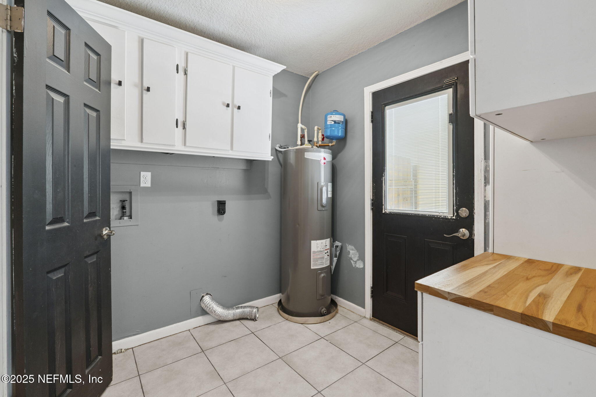 2822 Circle Ridge Drive Orange Park, FL 32065 - Photo 10 of 41 a kitchen with white cabinets and refrigerator