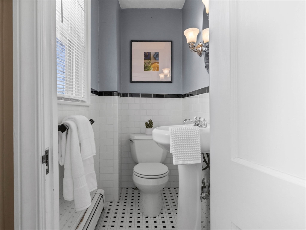 40 Chisholm Road Boston, MA 02131 - Photo 11 of 33 a bathroom with a toilet and a shower curtain