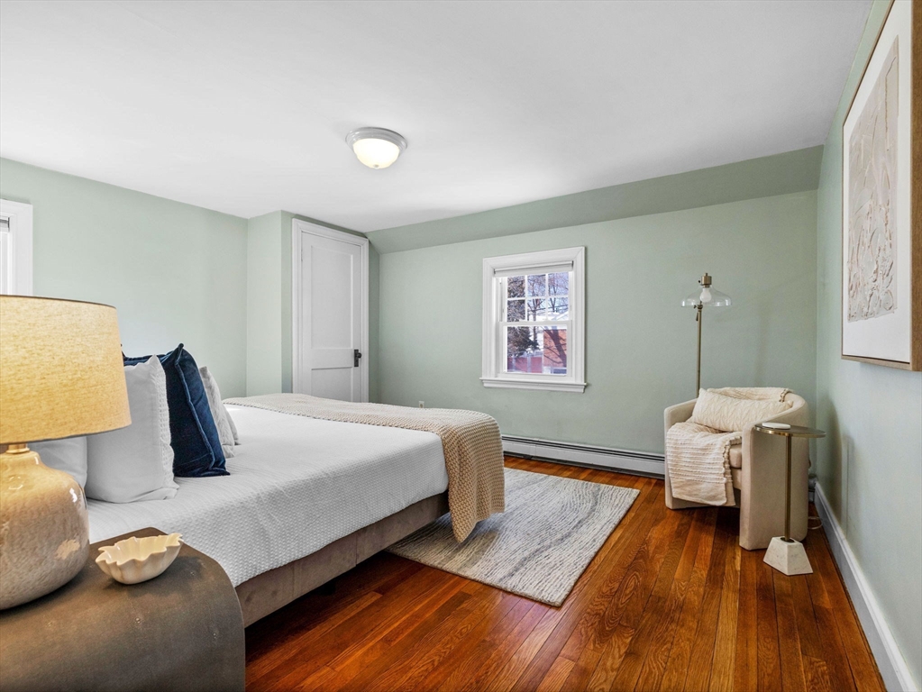 40 Chisholm Road Boston, MA 02131 - Photo 14 of 33 a bedroom with a bed and wooden floor