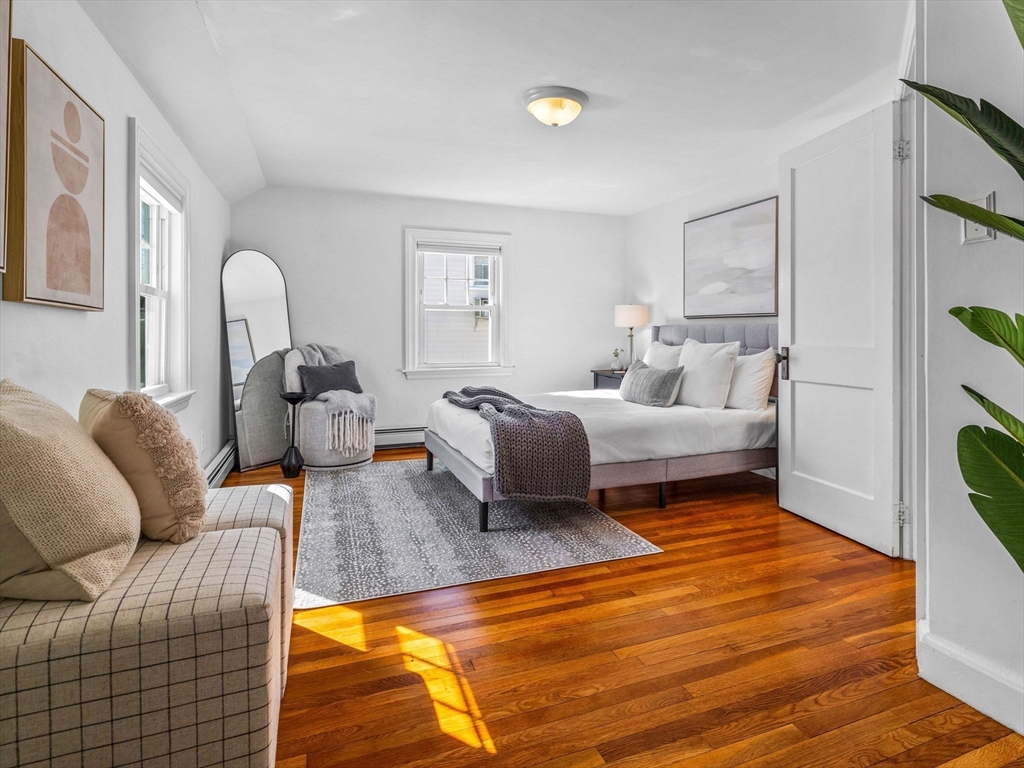 40 Chisholm Road Boston, MA 02131 - Photo 15 of 33 a spacious bedroom with a bed and a couch