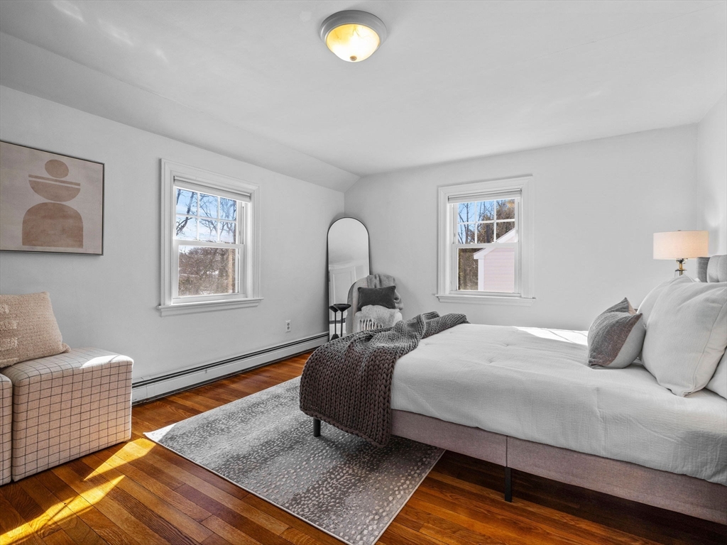 40 Chisholm Road Boston, MA 02131 - Photo 16 of 33 a bedroom with a bed and wooden floor