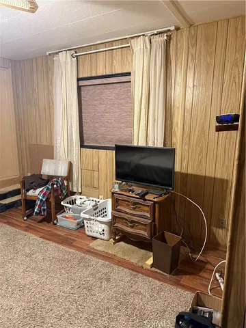 a spacious bedroom with a bed and a chandelier