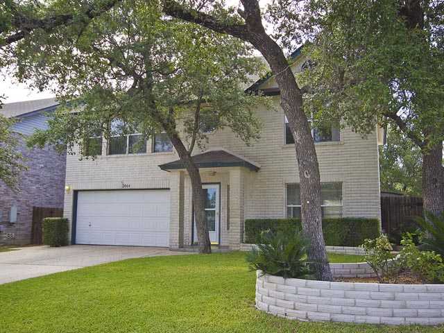 2004 Rachel Ridge Cedar Park, TX 78613 - Photo 1 of 1 a front view of a house with a yard and garage