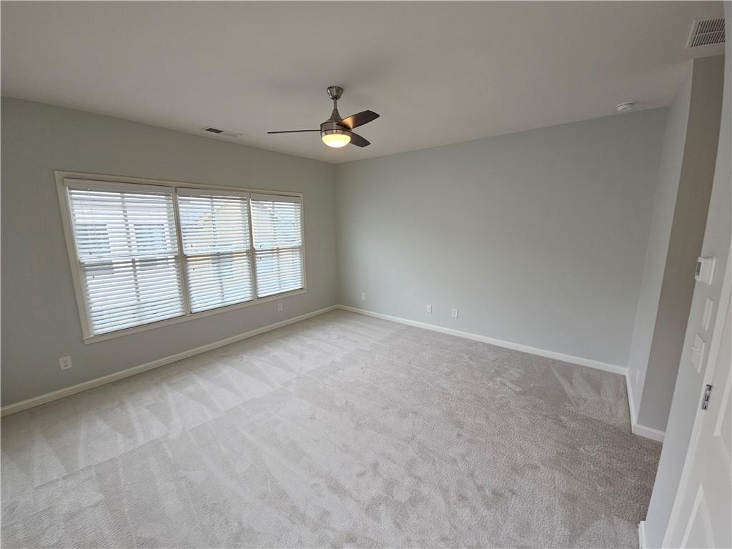 754 Dunlop Way Atlanta, GA 30312 - Photo 13 of 33 an empty room with chandelier fan and windows