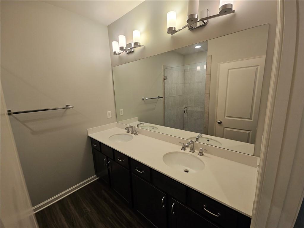 754 Dunlop Way Atlanta, GA 30312 - Photo 26 of 33 a bathroom with a double vanity sink and a mirror