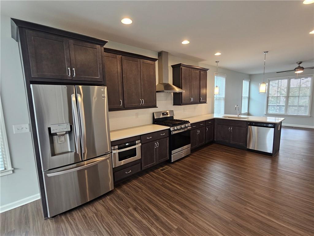 754 Dunlop Way Atlanta, GA 30312 - Photo 5 of 33 a large kitchen with wooden floors and stainless steel appliances