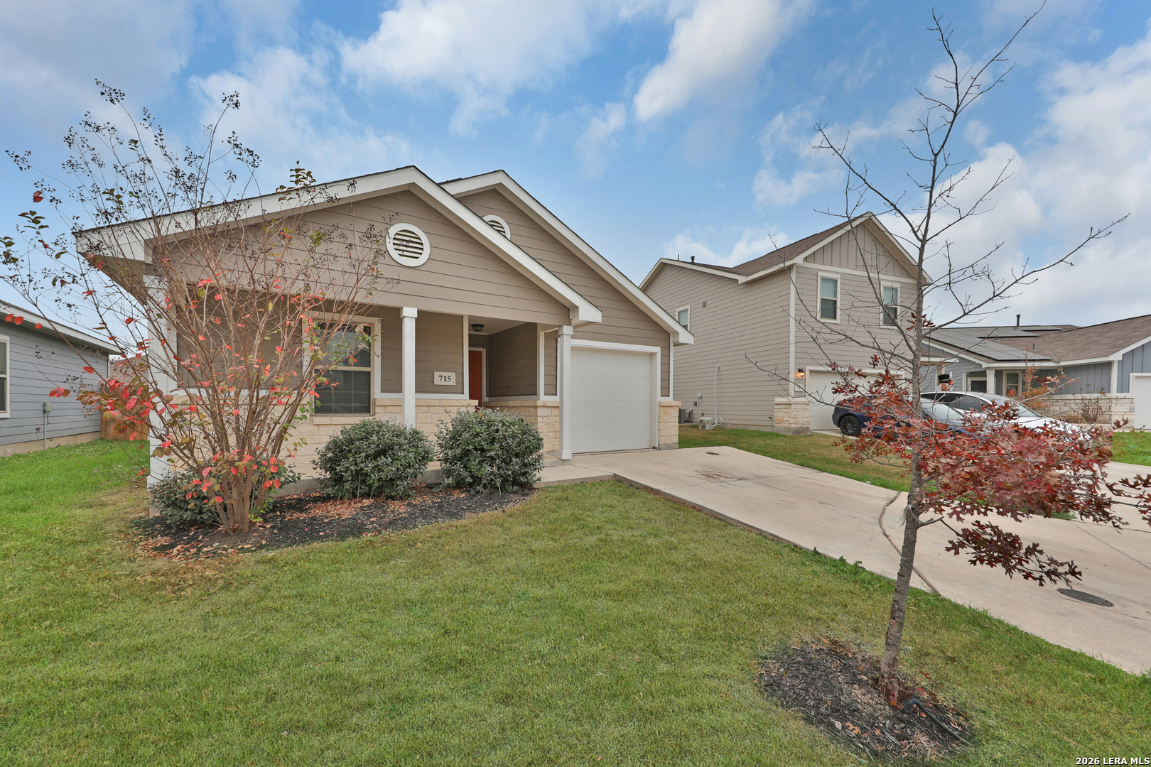 a front view of a house with a garden