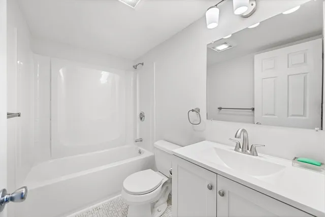 a bathroom with a sink toilet a bathtub and vanity