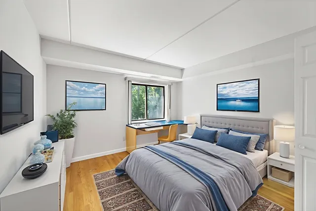 a bedroom with bed and a potted plant