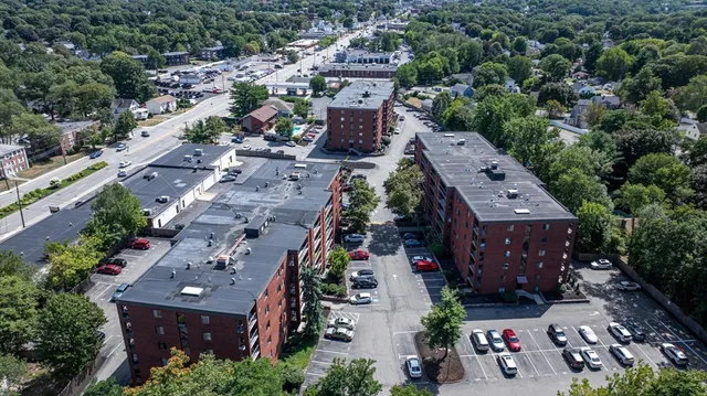 an aerial view of multiple houses with yard