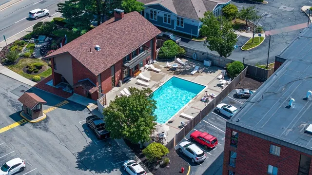 an aerial view of a house with a yard