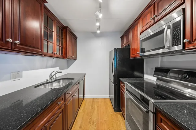 a kitchen that has a sink and stainless steel appliances