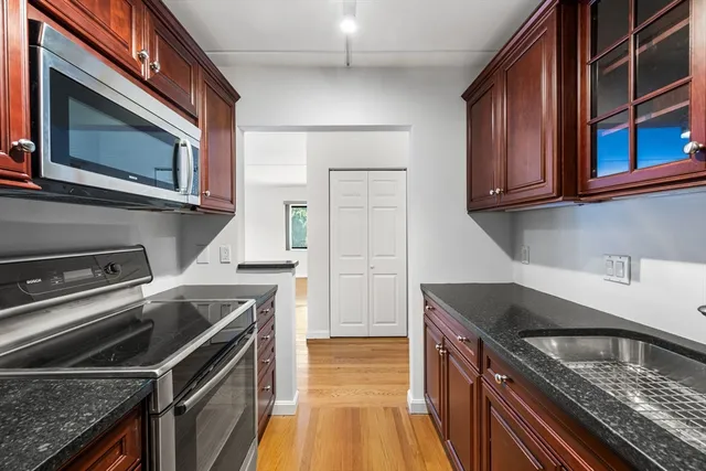 a kitchen with a stove microwave and sink
