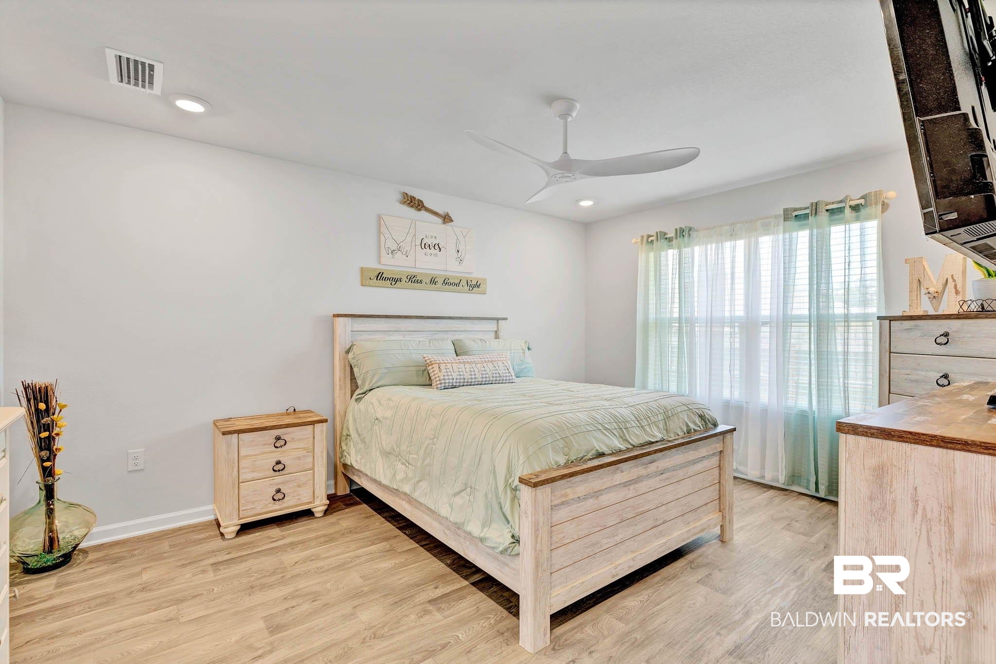 17217 REFLECTION Street Loxley, AL 36551 - Photo 20 of 83 Primary Bedroom off the great room with light wood lvp finished floors, a ceiling fan, and recessed lighting