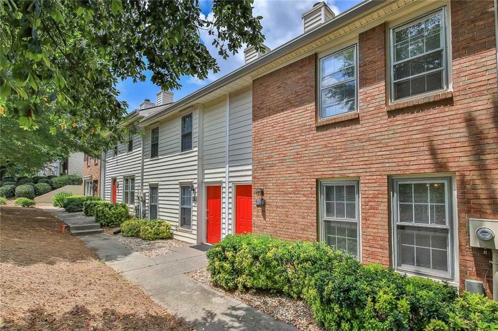 a front view of a house with plants