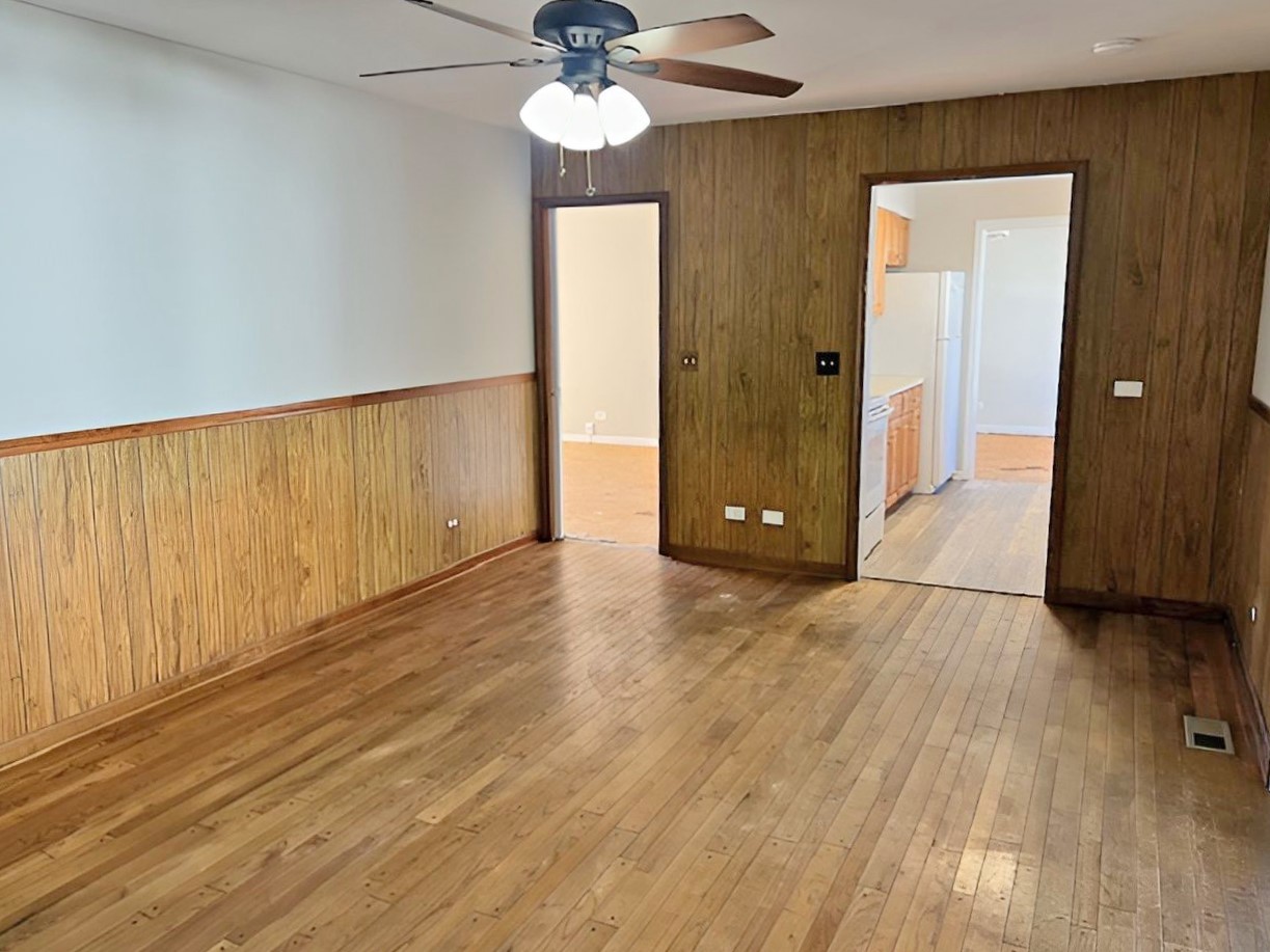 654 Longview Drive Antioch, IL 60002 - Photo 8 of 39 a view of an empty room with wooden floor and a ceiling fan