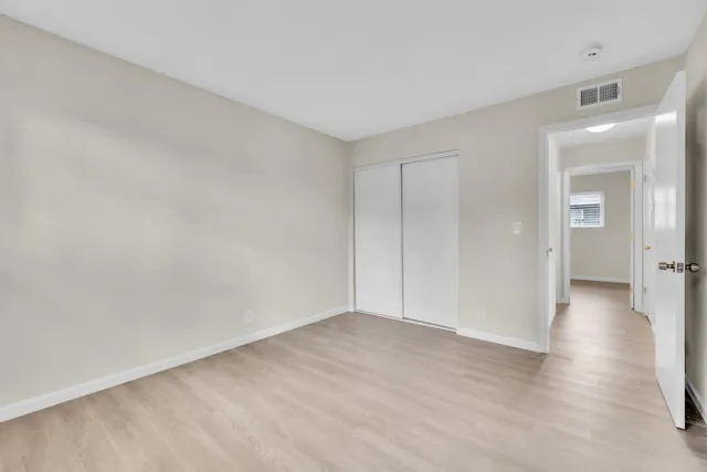 a view of an empty room and closet