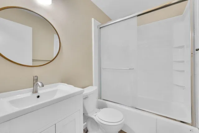 a bathroom with a toilet a sink and a mirror