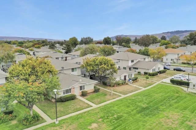 a view of a house with a yard and table and chairs