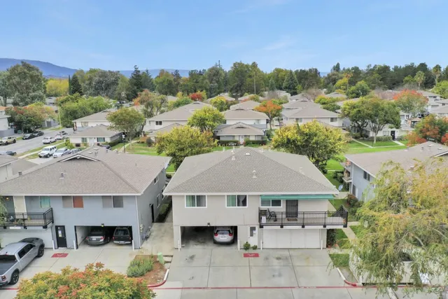 an aerial view of a house with swimming pool and furniture