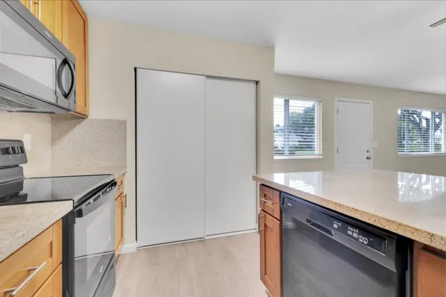 a kitchen with stainless steel appliances granite countertop a sink and a stove
