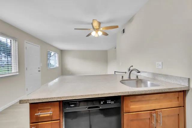 a kitchen with a sink a counter space and cabinets