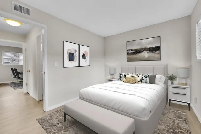 a bedroom with a bed and a couch