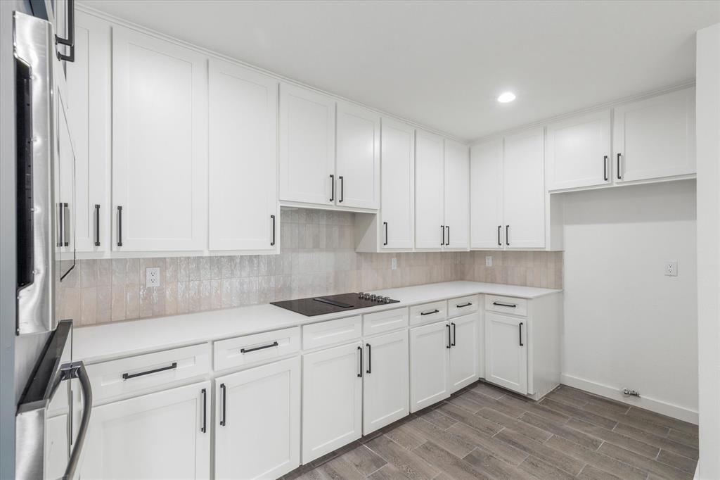 17003 Davenport Road Dallas, TX 75248 - Photo 14 of 40 a kitchen with white cabinets and sink