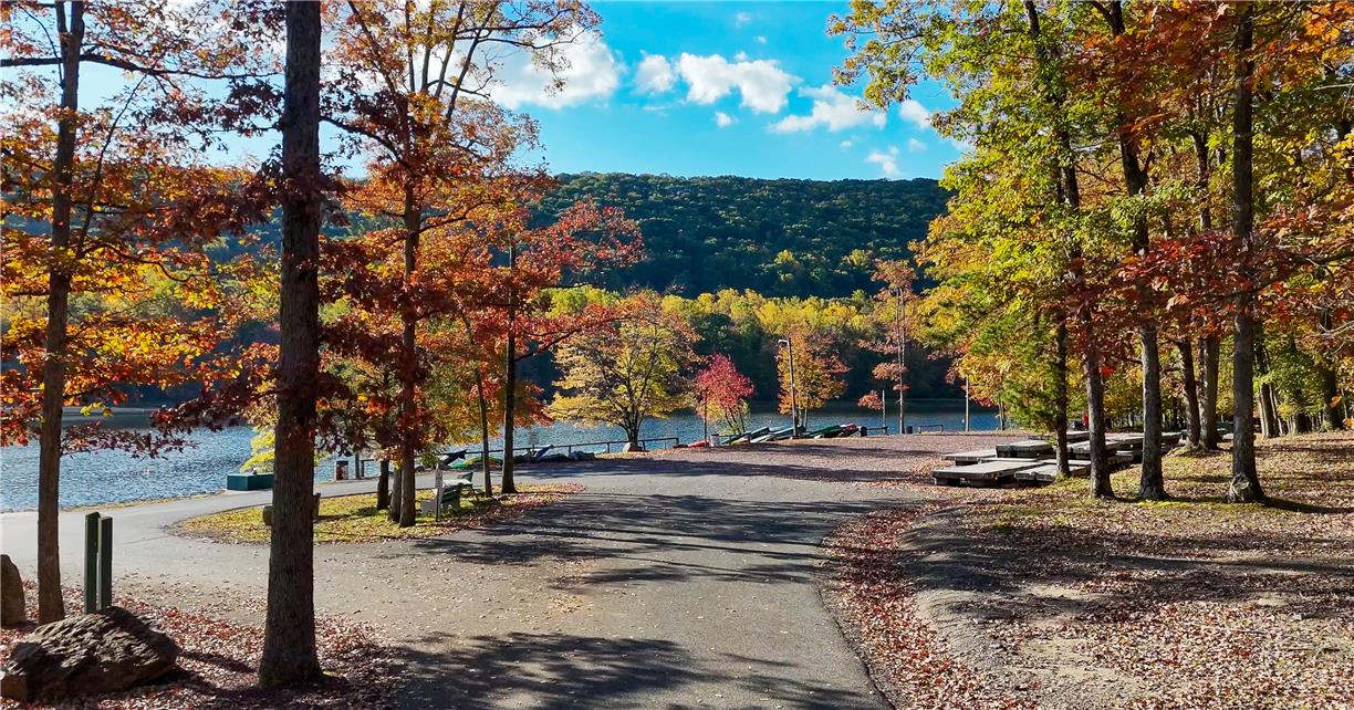 18 White Oak Road Nesquehoning, PA 18240 - Photo 46 of 52 A picturesque lakefront setting, surrounded by vibrant fall foliage, provides a serene outdoor escape.