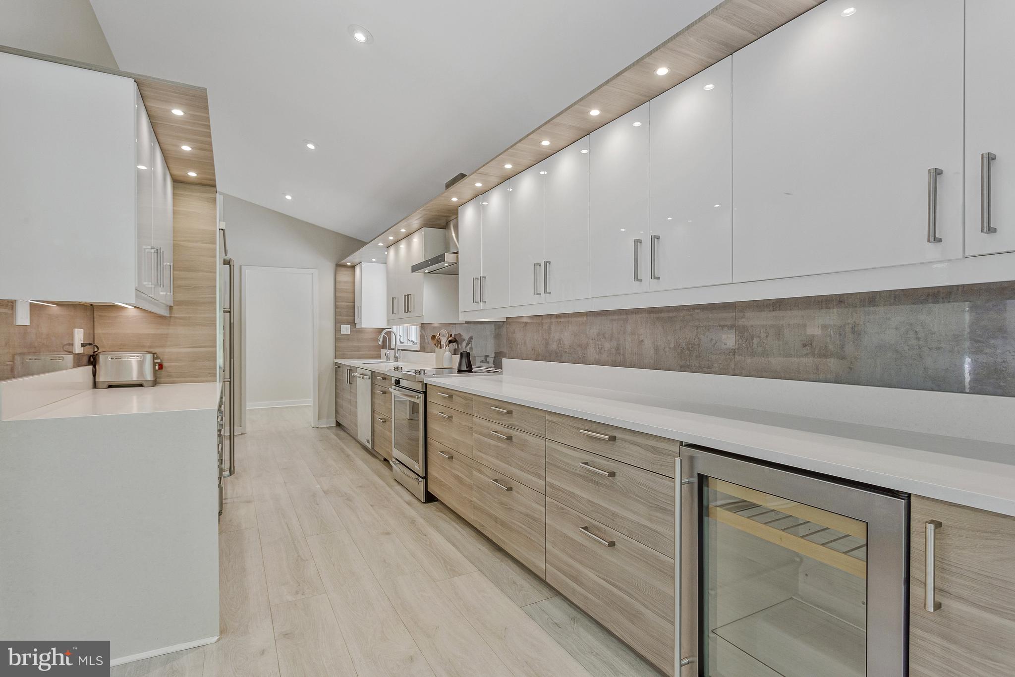 718 Springvale Road Great Falls, VA 22066 - Photo 14 of 57 a kitchen with granite countertop white cabinets and white appliances