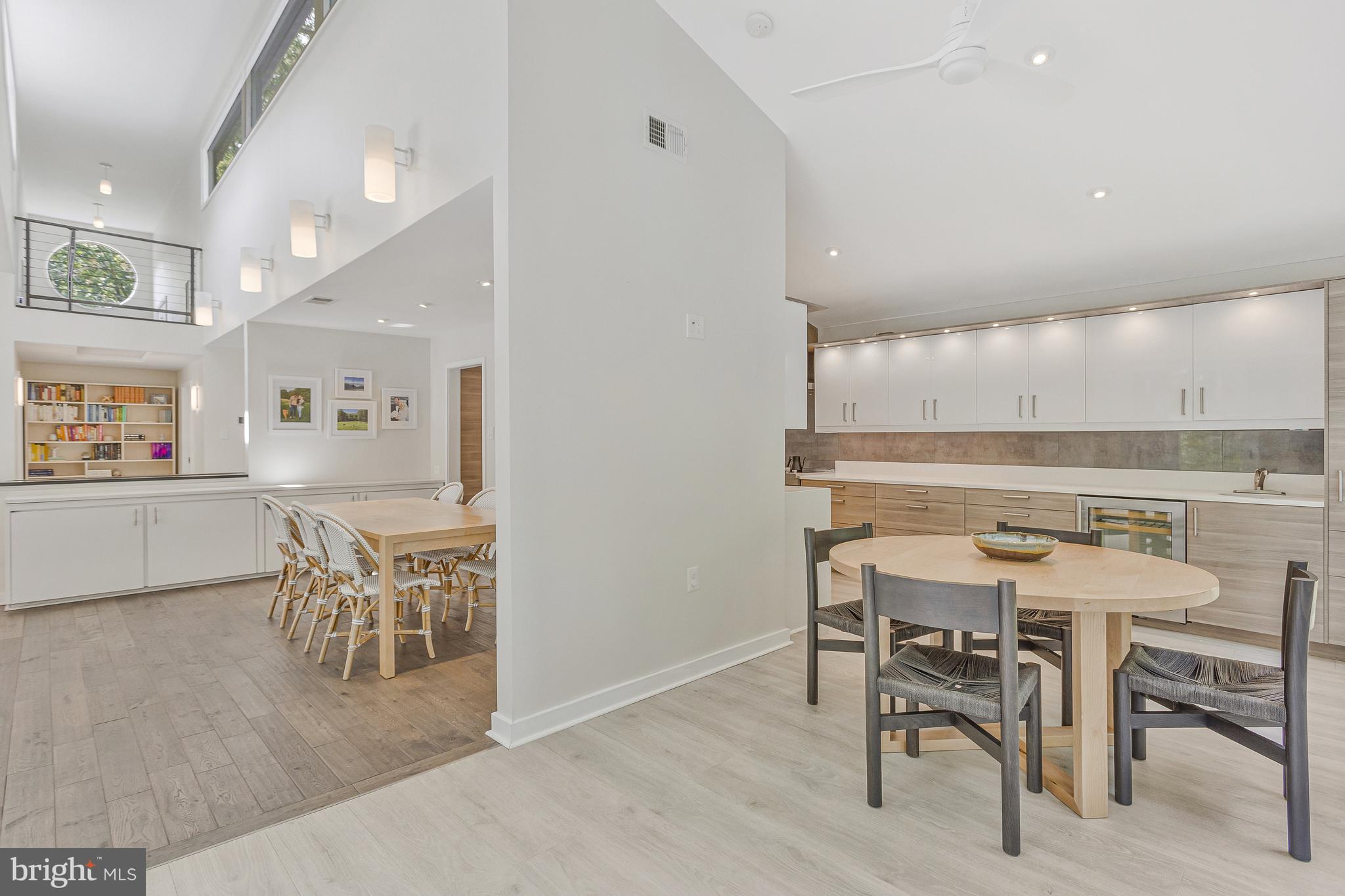 718 Springvale Road Great Falls, VA 22066 - Photo 15 of 57 a view of a dining room with furniture and a kitchen