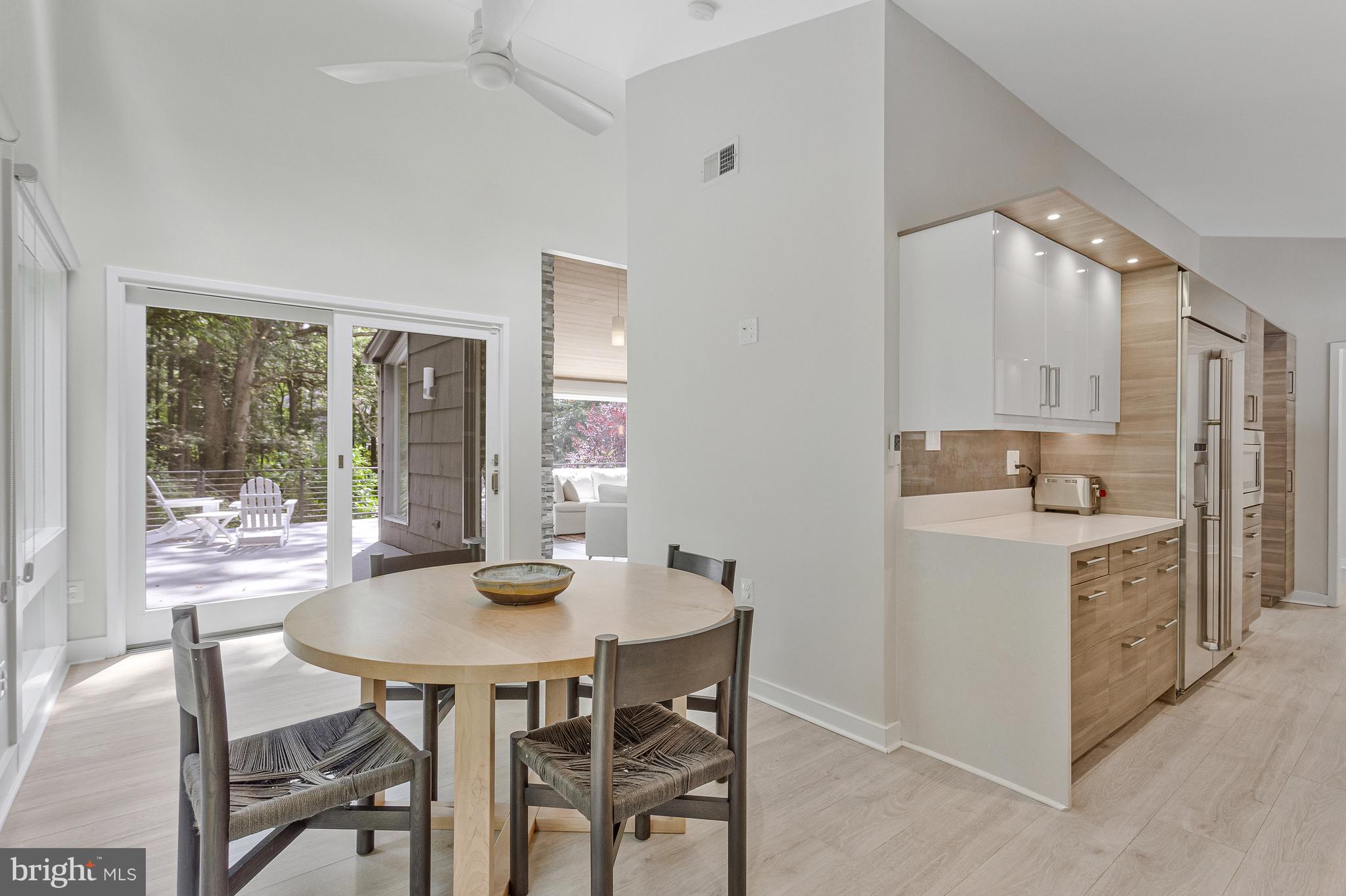 718 Springvale Road Great Falls, VA 22066 - Photo 17 of 57 a kitchen with a table chairs stove and cabinets
