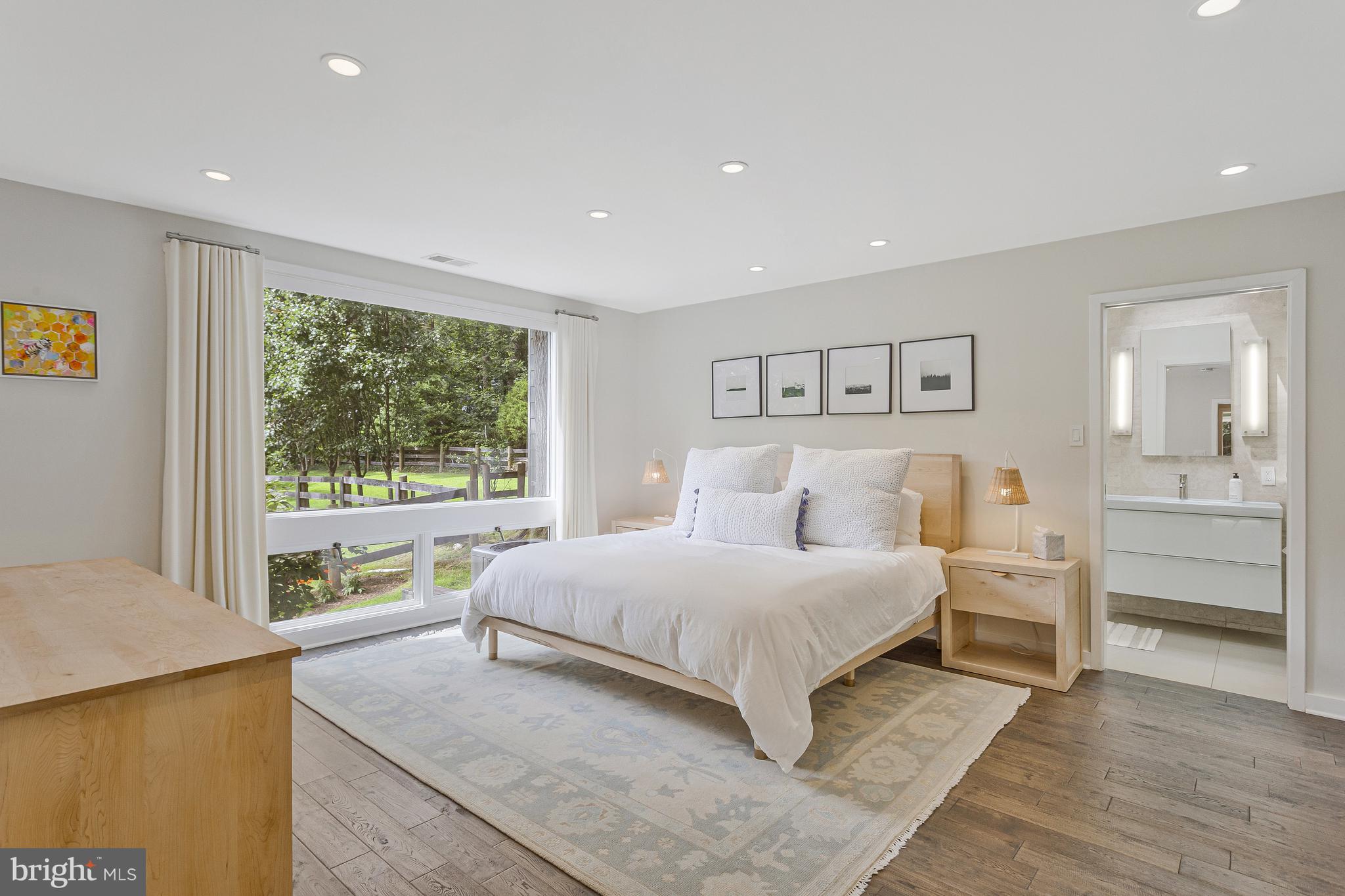 718 Springvale Road Great Falls, VA 22066 - Photo 19 of 57 a bedroom with a large bed and a large window