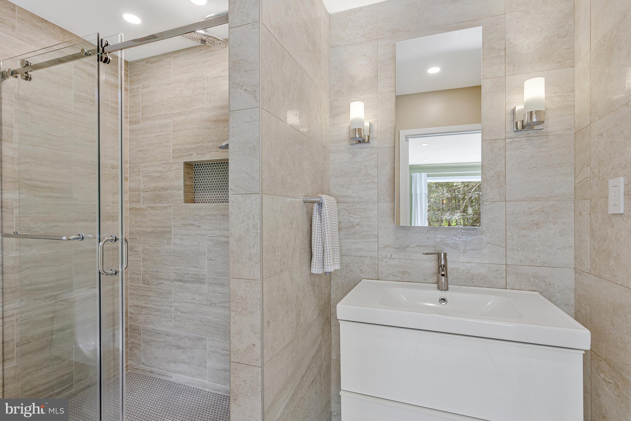 718 Springvale Road Great Falls, VA 22066 - Photo 25 of 57 a bathroom with a sink a toilet and shower