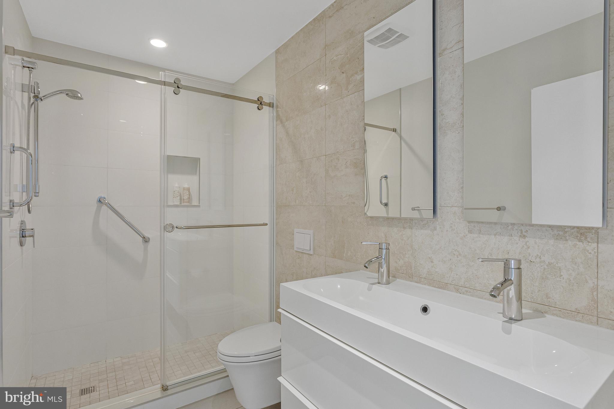 718 Springvale Road Great Falls, VA 22066 - Photo 33 of 57 a bathroom with a sink a toilet and shower