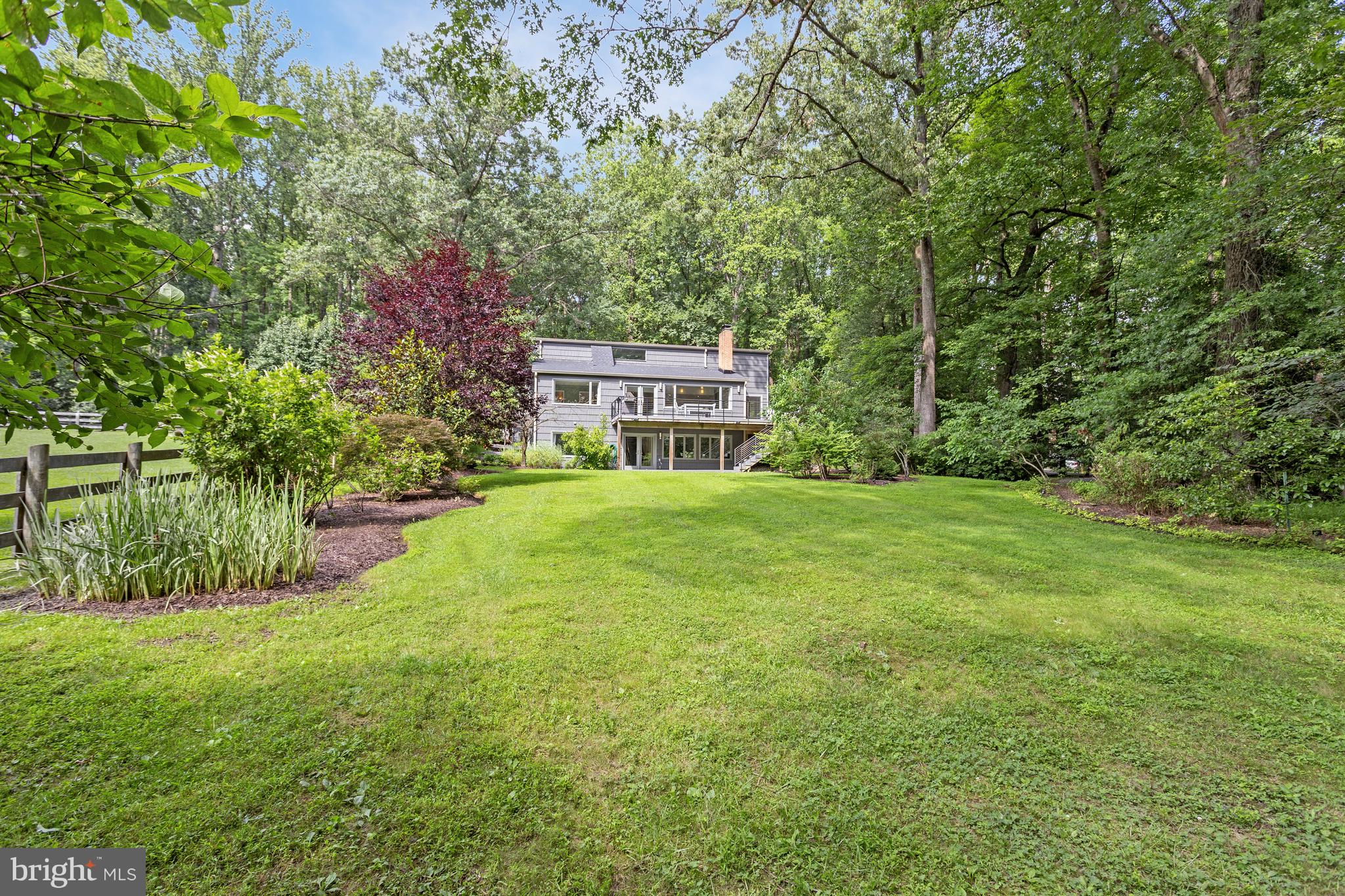 718 Springvale Road Great Falls, VA 22066 - Photo 48 of 57 a view of a house with a big yard and large trees