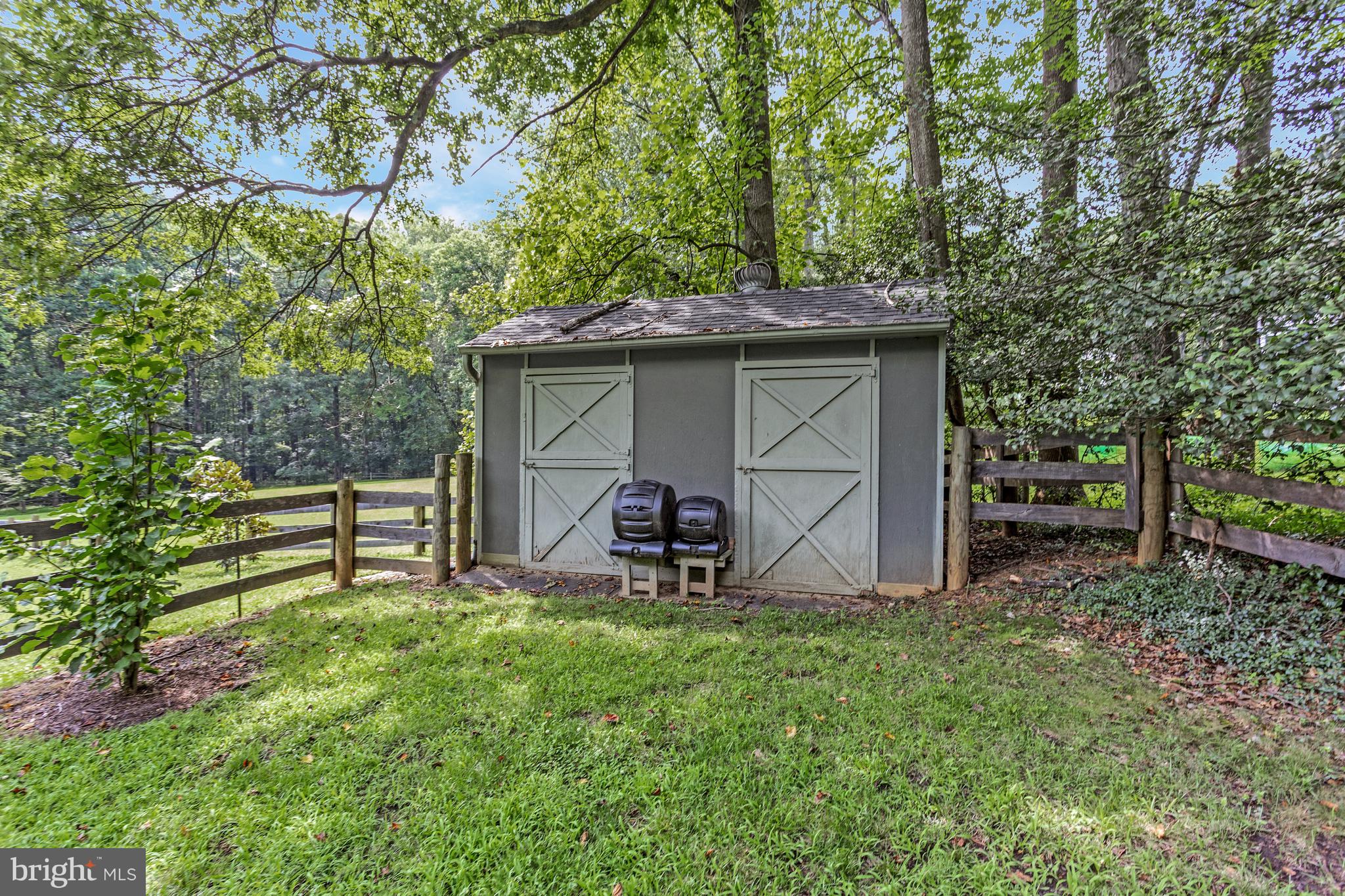 718 Springvale Road Great Falls, VA 22066 - Photo 53 of 57 a view of a chair and table in backyard of the house