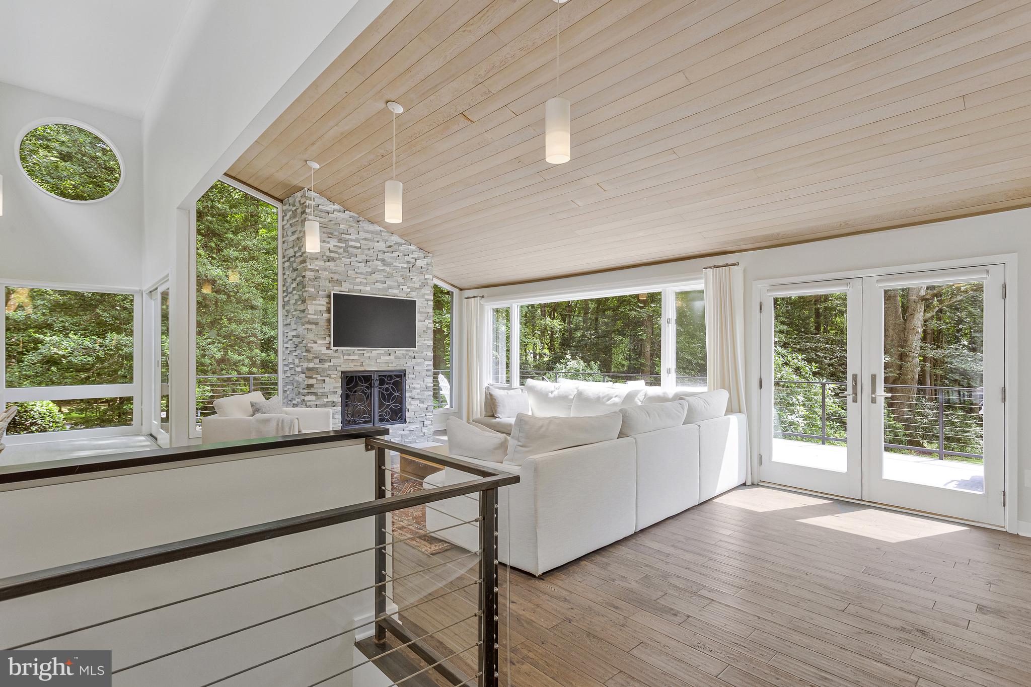 718 Springvale Road Great Falls, VA 22066 - Photo 6 of 57 a living room with furniture and large windows