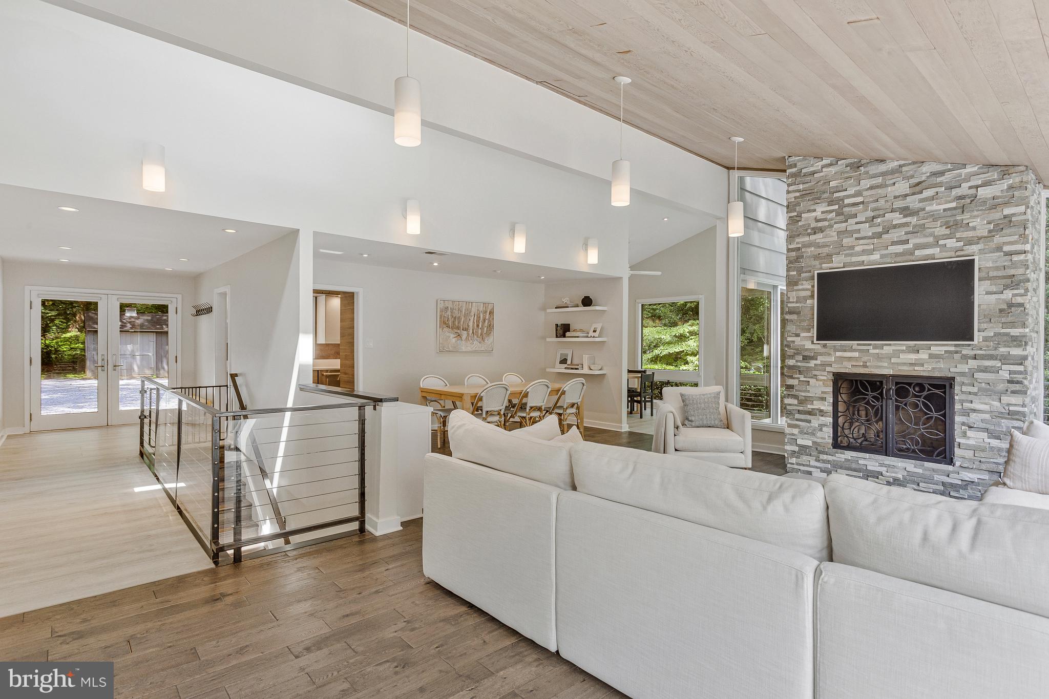 718 Springvale Road Great Falls, VA 22066 - Photo 7 of 57 a living room with furniture a fireplace and a flat screen tv
