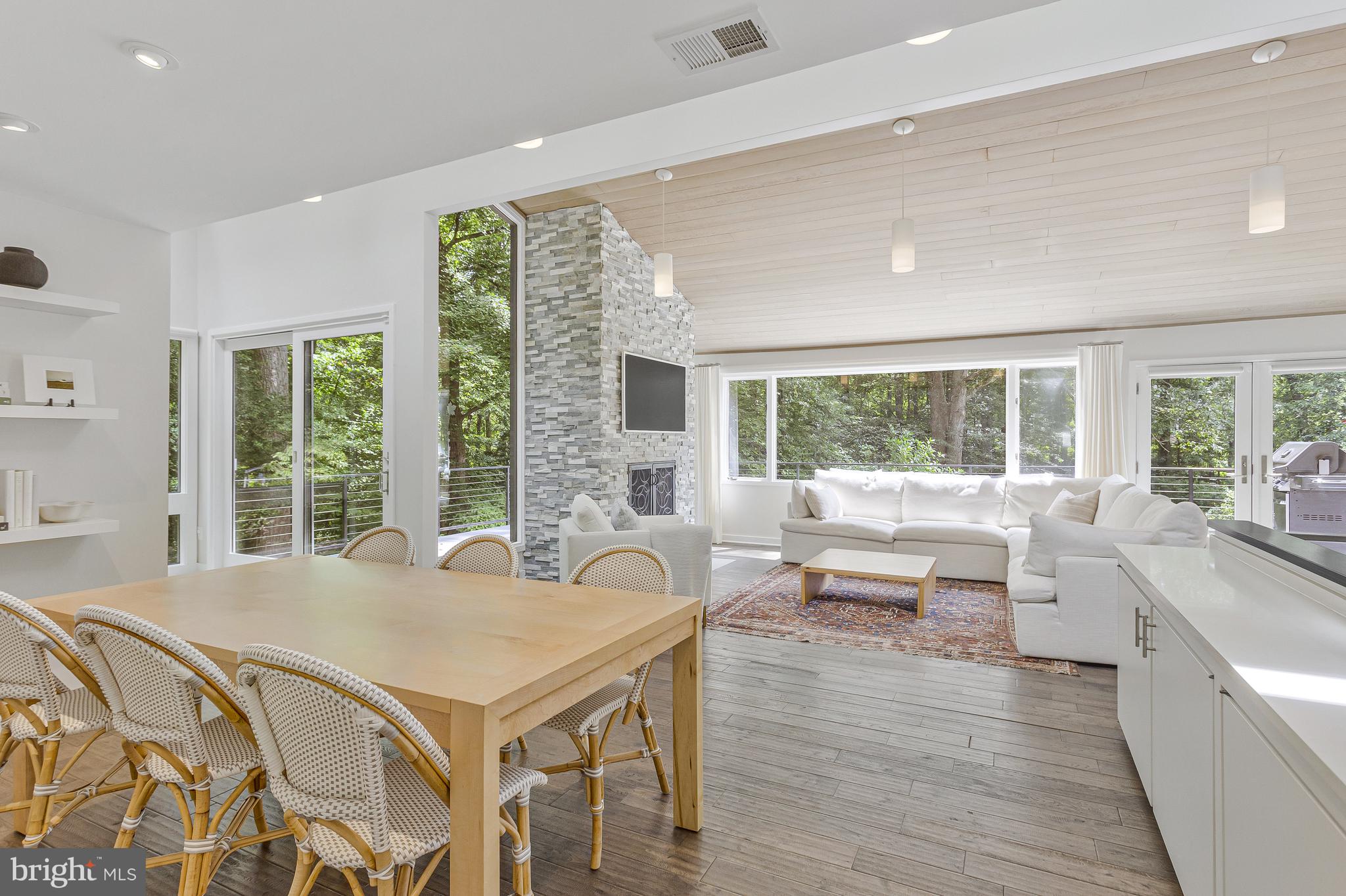 718 Springvale Road Great Falls, VA 22066 - Photo 10 of 57 a living room with furniture and large windows