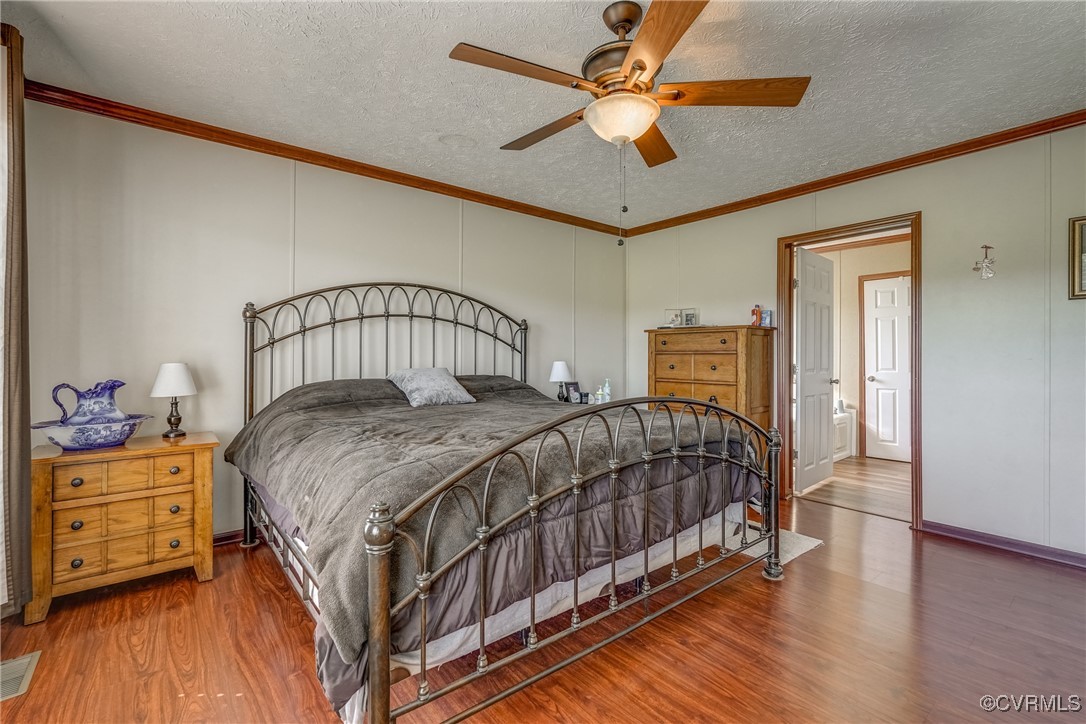 6779 South Hill Road Kenbridge, VA 23944 - Photo 17 of 50 Bedroom with crown molding, hardwood / wood-style