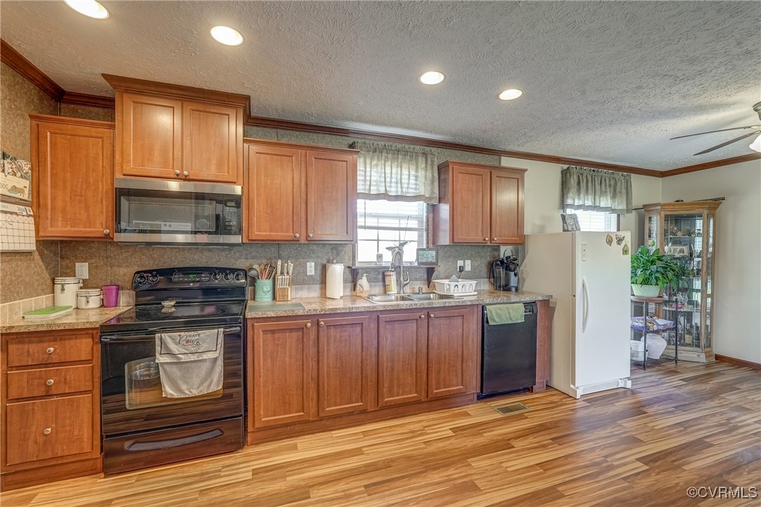6779 South Hill Road Kenbridge, VA 23944 - Photo 27 of 50 Kitchen featuring light wood-type flooring, crown
