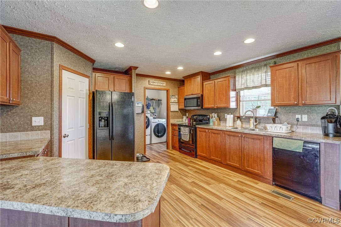 6779 South Hill Road Kenbridge, VA 23944 - Photo 29 of 50 Kitchen with sink, black appliances, washing machi