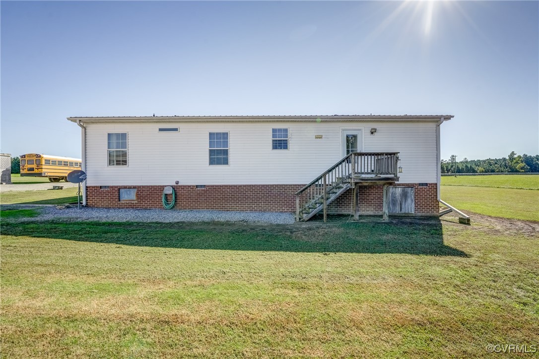 6779 South Hill Road Kenbridge, VA 23944 - Photo 32 of 50 Back of house featuring a wooden deck and a lawn