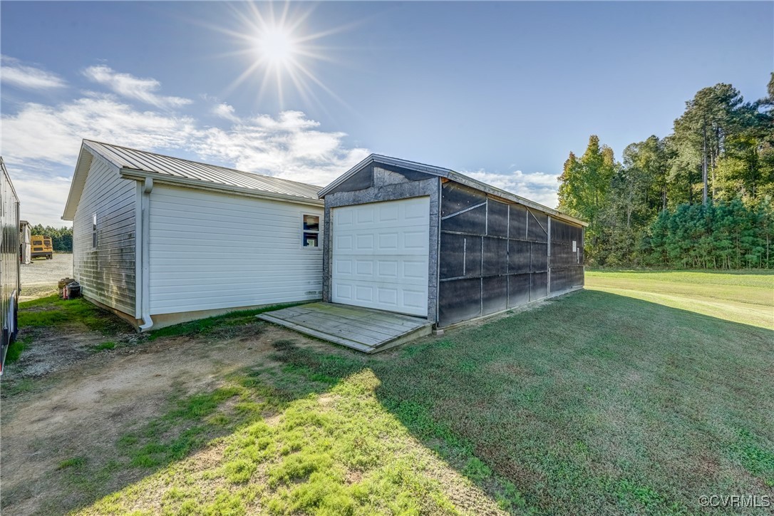 6779 South Hill Road Kenbridge, VA 23944 - Photo 39 of 50 View of outdoor structure with a garage and a yard