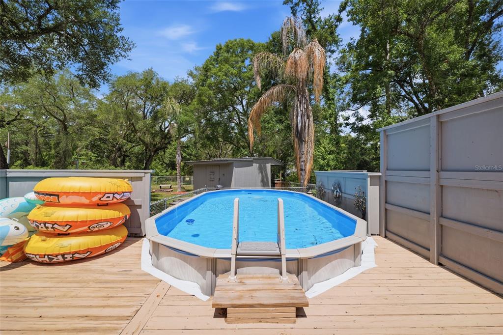 3183 Cedley Road Dade City, FL 33523 - Photo 21 of 48 a view of a swimming pool with a lounge chairs
